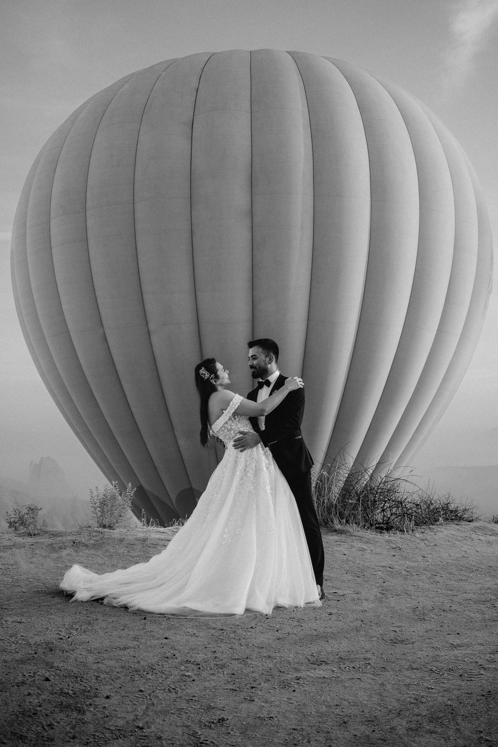 Couple in front of hot air balloon in Turkey on their wedding day.