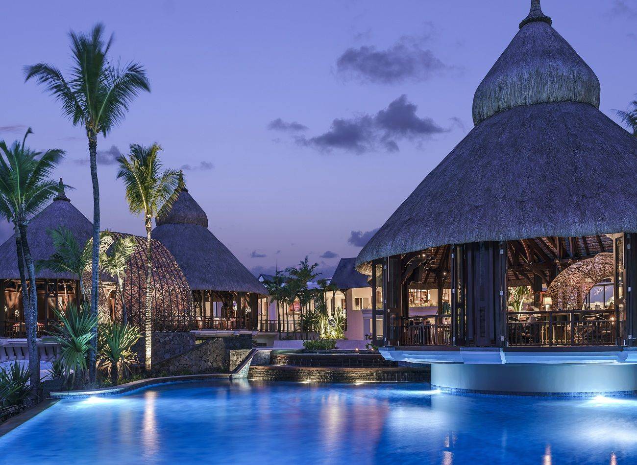 Luxurious pool with wooden villas