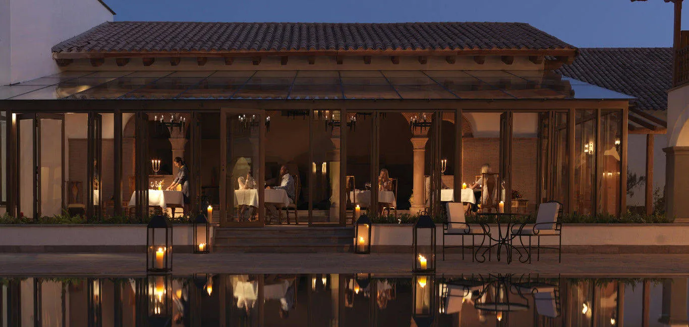 Wooden restaurant area next to calm pool