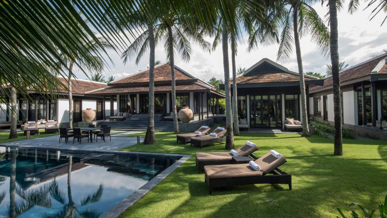 Beautiful poolside area with lounge seating and villas