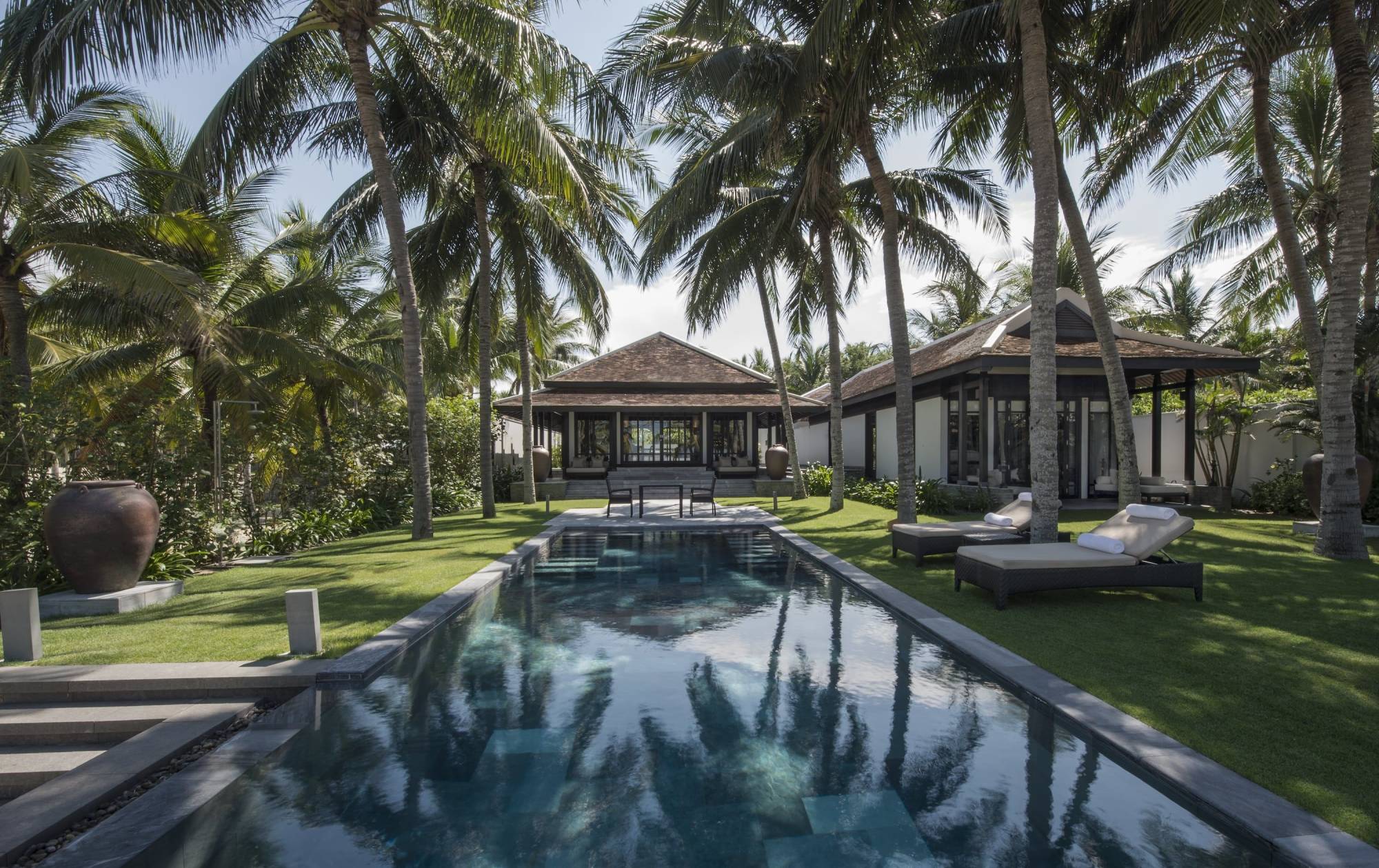 Pool with lounge chairs and villas
