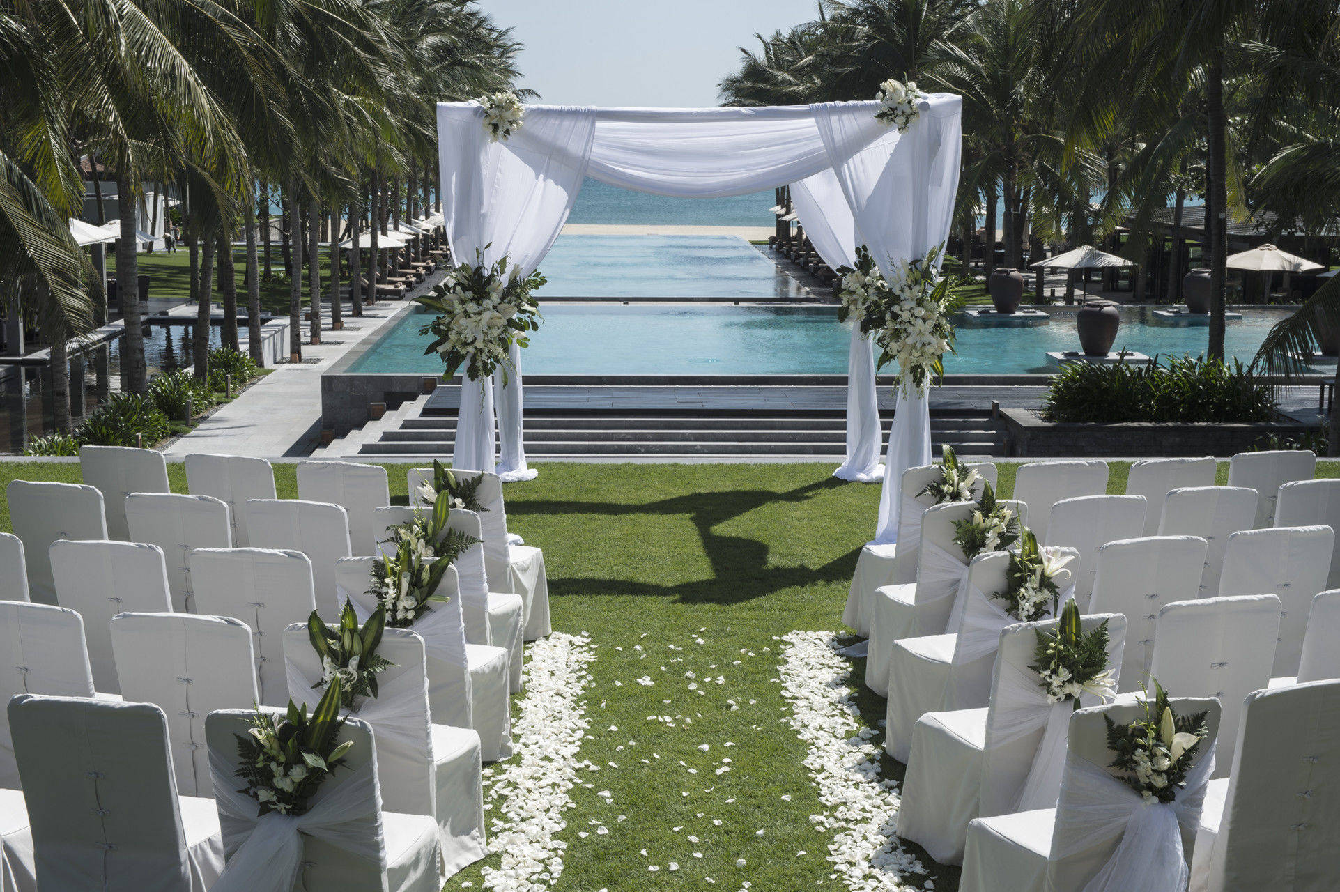 Poolside wedding ceremony with gorgeous sea view