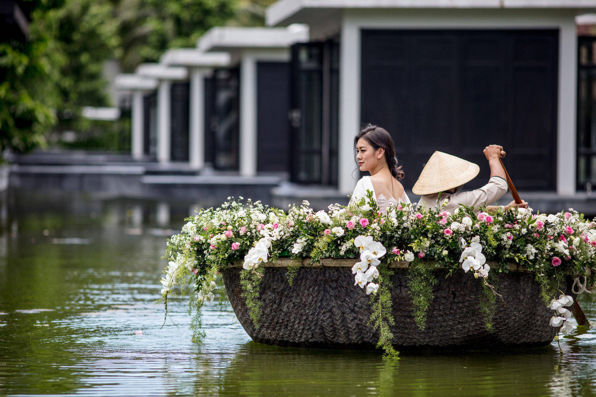 Bride in boat with flowers in lake