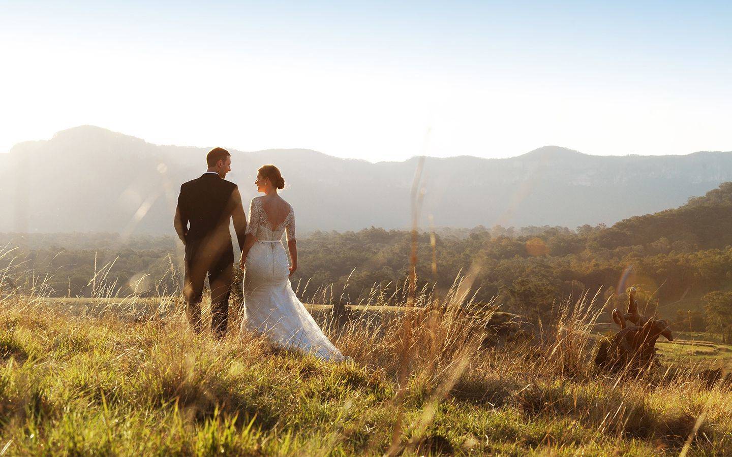 Couple looking at view of mountains and fields