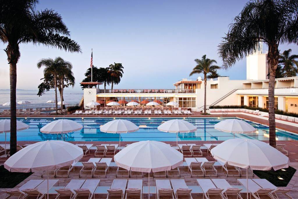 swimming pool chairs beside a swimming pool at the Four Seasons Resort The Biltmore Santa Barbara