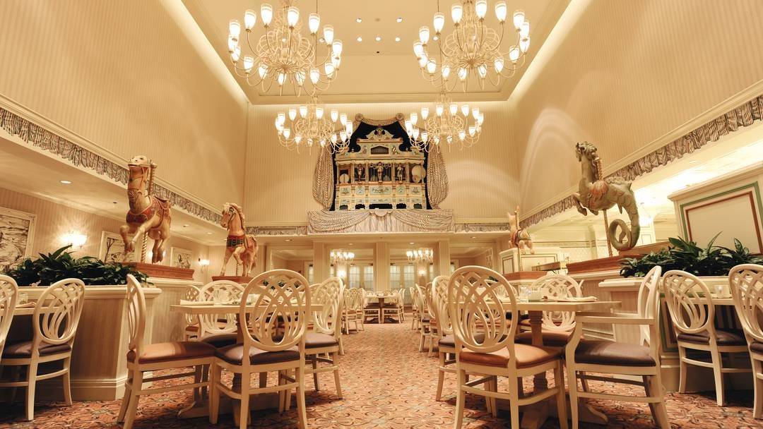 restaurant with four chandeliers and carpeted ground at the Disneys Grand Floridian Resort & Spa