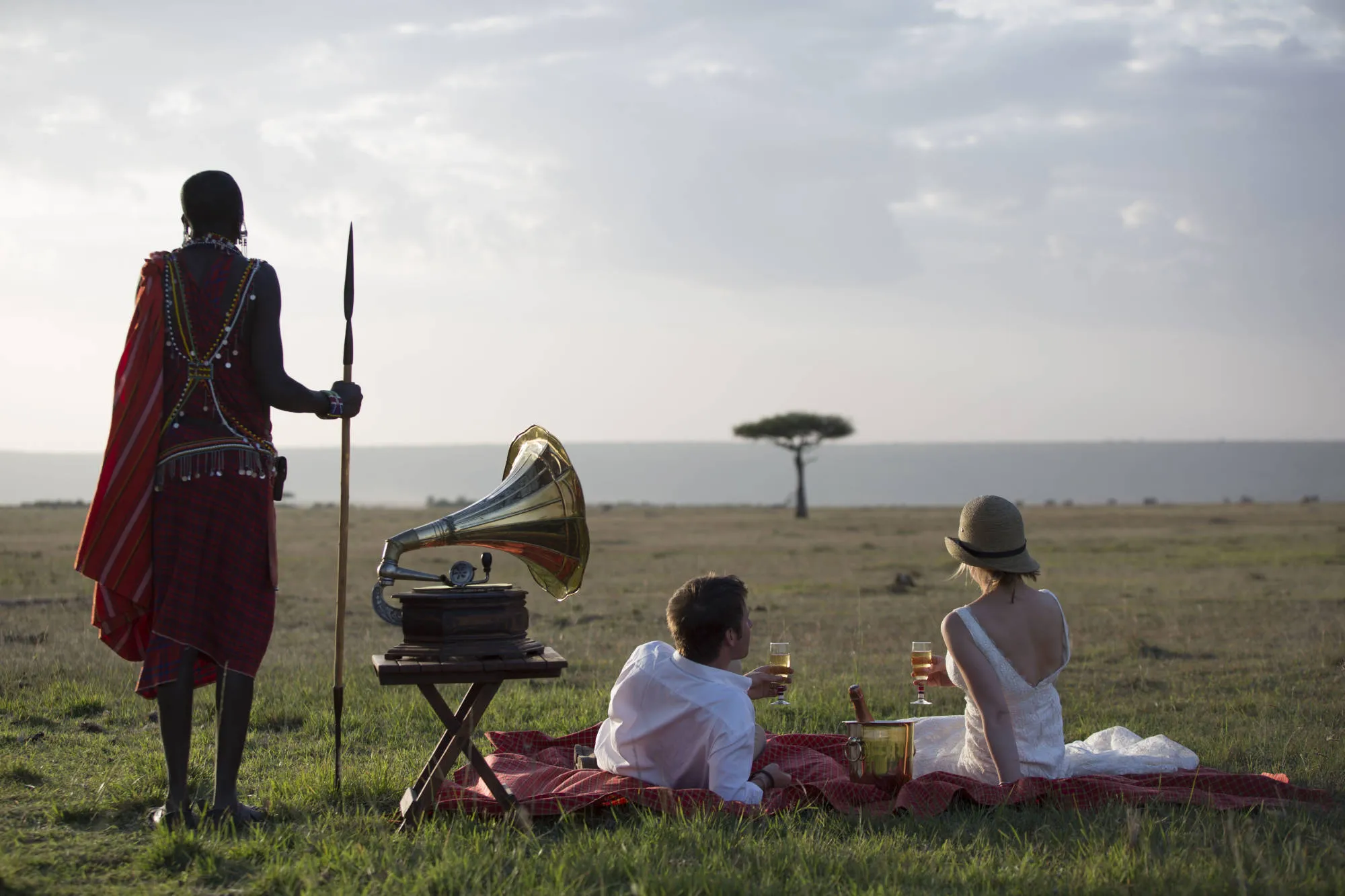 Bride and groom sat in a field in East Africa